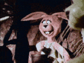 a cartoon rabbit is smiling and holding a spoon