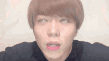 a close up of a person 's face with a pink lip .
