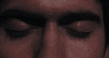 a close up of a man 's eyes with his eyes closed