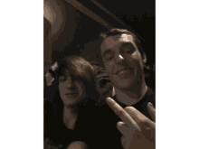 two young men are giving the middle finger