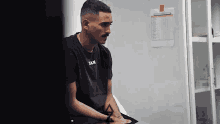 a man in a black shirt that says sam