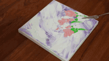 a purple and white painting with flowers on it