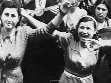 a group of women are dancing in a black and white photo taken by markus world
