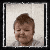 a picture of a baby in a frame with a white border