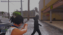 a screenshot of a video game shows a man pointing a gun