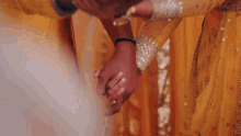 a man and woman holding hands with a yellow background