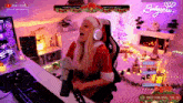 a woman in a santa outfit is sitting at a desk