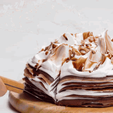 a stack of pancakes with whipped cream on top