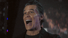 a man is laughing with his mouth open