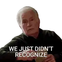 an elderly man holding a piece of paper with the words we just did n't recognize written below him