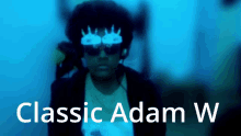 a man wearing sunglasses and headphones with the words classic adam w below him