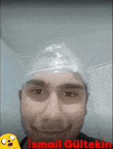 a man with a plastic bag on his head and the name ismail gultekin on the bottom right