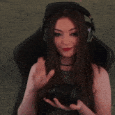 a woman wearing headphones holds a camera in her hands