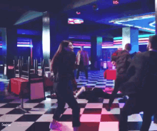 a group of people are dancing in a club with the name sophie on the bottom right