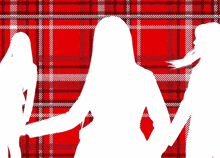 a woman walking in front of a plaid background