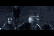 a man without a shirt is fighting another man in a dark room in a black and white photo .