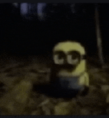 a close up of a minion wearing sunglasses in the dark .