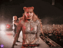 a woman on a stage with the words say whattt on the bottom