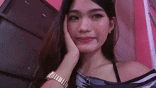 a woman wearing a watch on her wrist is taking a selfie