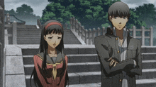 a boy and a girl are standing next to each other on a set of stairs with trees in the background