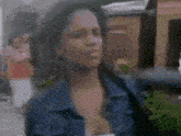 a blurry picture of a woman in a blue denim jacket
