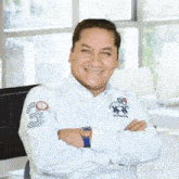 a man with his arms crossed wearing a polo shirt with the number 3 on it