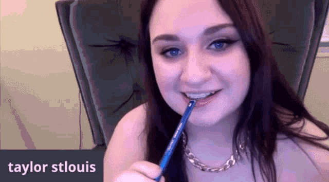 a woman holding a pencil in her mouth with the name taylor stlouis on the bottom right