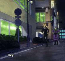 a man walking down a street with a sign that says hey on it
