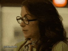 a close up of a woman wearing glasses with the hashtag lialmeida05 on the bottom