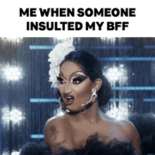 a drag queen with a flower in her hair and the words me when someone insulted my bff below her