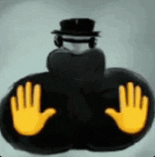 a man in a top hat is sitting on the floor with his hands up .