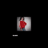 the girl is wearing a red jacket and headphones and holding a skateboard .