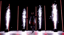 a woman is standing in front of a row of fireworks ..