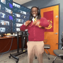 a man wearing headphones and a red sweater is dancing
