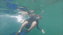 a man wearing goggles and flippers is swimming in the water
