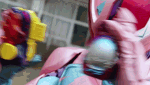 a blurred image of a person in a pink suit holding a gun