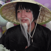 a woman wearing a hat and a fake mustache is smiling