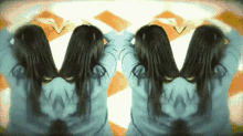 two women are standing next to each other with their hands in their hair