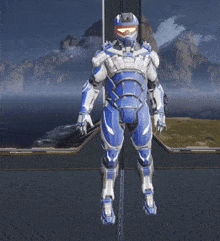 a video game character in a blue and silver armor is flying through the air