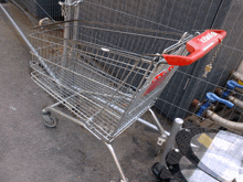 a shopping cart has a red handle that says retail
