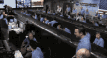 a blurred image of a group of people in a nasa control room