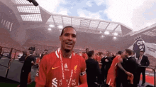 a soccer player wearing a red jersey that says premier league
