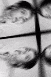 a black and white photo of a person 's face with a reflection