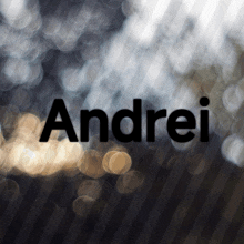 a blurry picture of the name andrei on a dark background