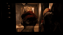 a woman in a bra is standing in a dark room