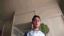 a boy wearing a shirt that says ' billabong ' on the front