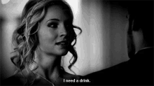 a woman says i need a drink while looking at a man in a black and white photo