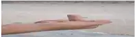 a close up of a person 's hand pointing to the side