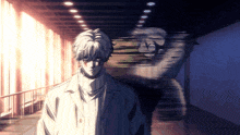 a man in a white coat stands in a hallway