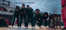 a group of people standing in front of a sign that says 3:45 moj mozg na matmie